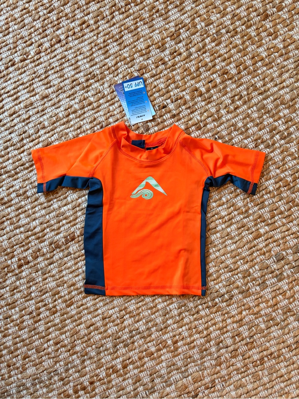 Kanu Surf Orange and Navy Kids Rashguard sun protection shirt for beach or pool.
